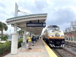 Northbound Sunrail Commuter Train # P324 arrives into Sand Lake Station behind MP32PH-Q # 106 on the point.